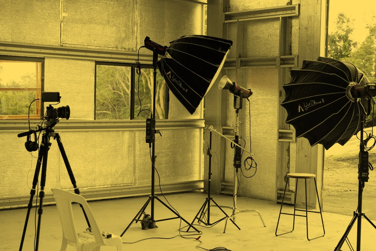 A film studio set with softbox lights and a camera on a tripod